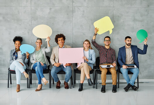 Portrait of a group of young business people in office. Speech bubble, team and comment by business people holding sign, news and voice icon feeling excited on social media. Group, opinion and poll by