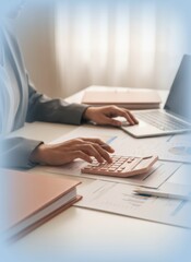 Fototapeta premium Person working at an office desk with a calculator and laptop for financial management, corporate budgeting and data analysis with a soft blue vignette border
