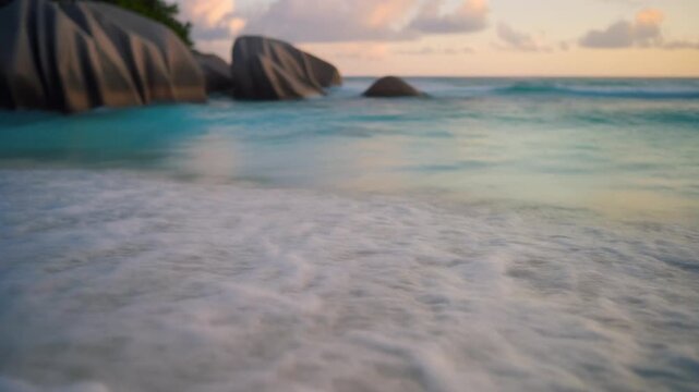 Tropical beach waves at La Digue Island Seychelles at sunset
