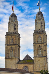 Fototapeta premium Grossmunster Church Twin Towers and Facade with Flags in Zurich Switzerland
