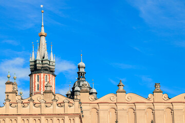 Naklejka premium Gothic spires and ornate facade of historic European town hall against blue sky