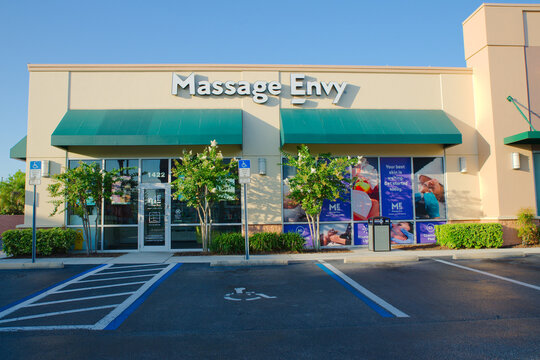 Massage Envy Spa Storefront With Accessible Parking, Green Awnings and Window Graphics Editorial Use Only St. Petersburg, FL  USA June 12, 2026 promotional window graphics conveying wellness, relaxati
