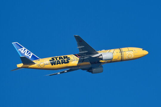 All Nippon Airways (ANA) Boeing 777-200ER (JA743A) passenger plane in special "C-3PO ANA JET" livery taking off from Haneda Airport.