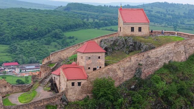 Picturesque aerial view revealing the historic Rupea Citadel, a medieval fortress perched atop a basalt hill in Transylvania, Romania