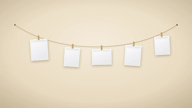 Blank instant photos hanging on string with wooden clothespins swaying gentle animation