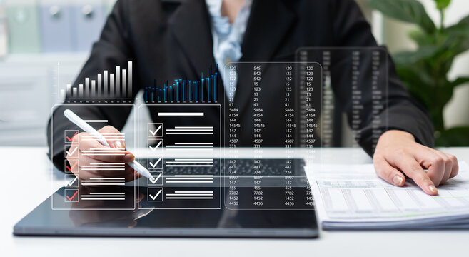 Businesswoman reviewing performance reports and compliance checklist on digital dashboard, data analytics, financial auditing, project management, reporting accuracy, and corporate governance.