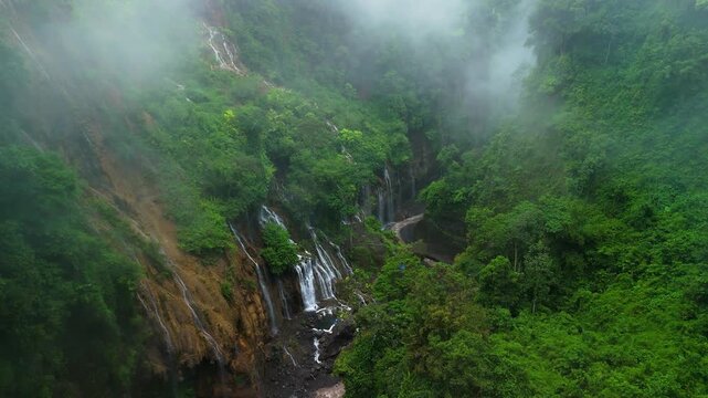 Cinematic Drone Shot of Tropical Waterfalls in Tumpak Sewu Waterfall Canyon &ndash; Java Island Indonesia