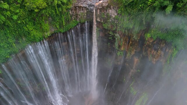 Tumpak Sewu Waterfall Rising from Misty Clouds | Aerial Drone Shot Java Island Indonesia