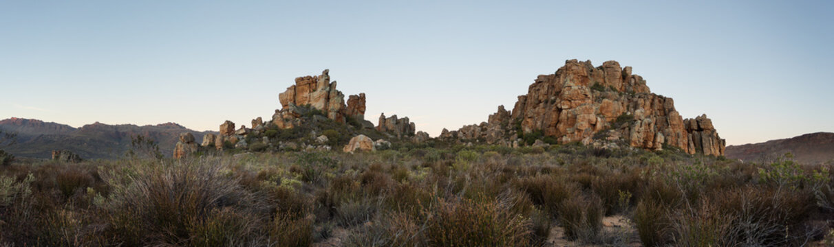 Rocky granite peaks in arid scrubland landscape