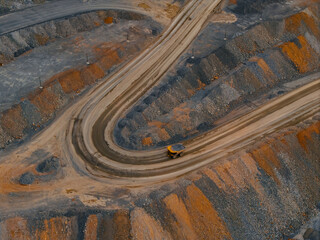 Mining haul truck navigating curved road in open pit quarry, gold mining industry aerial view © Parilov