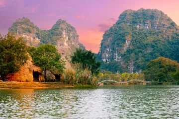 Fototapeten Naturpark Old village Tam Coc National Park and river in Ninh Binh, Vietnam  © Parilov
