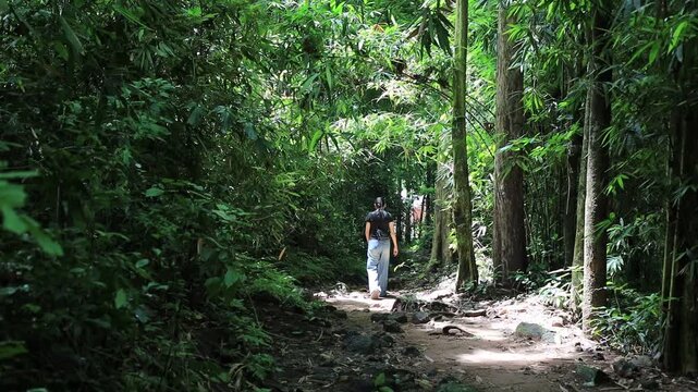 The video background features a natural landscape of a waterfall in a lush forest. Sam Lan Waterfall in Saraburi National Park boasts beautiful flowing water surrounded by diverse flora.