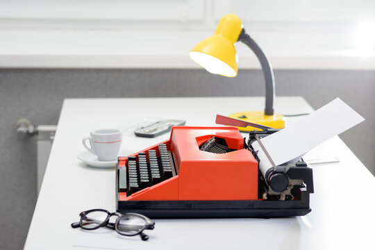 Writer desk with vintage typewriter and coffee cup