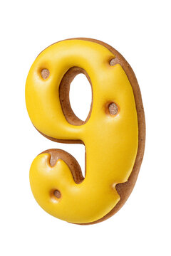 Gingerbread cookie shaped as a number nine with bright yellow icing isolated. Transparent PNG image.