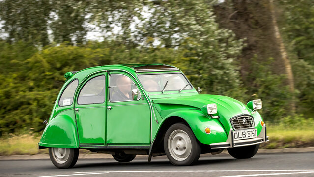 Stony Stratford,Bucks,UK - June 7th 2026: 1978 green Citroen 2CV classic  car driving on a British road