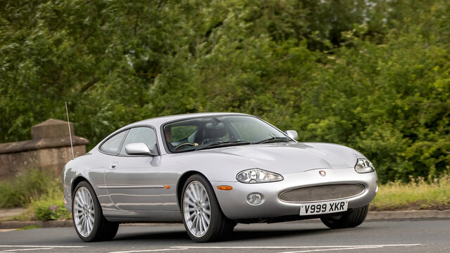 Stony Stratford,Bucks,UK - June 7th 2026: 2002 silver Jaguar xkr  classic car driving on a British road