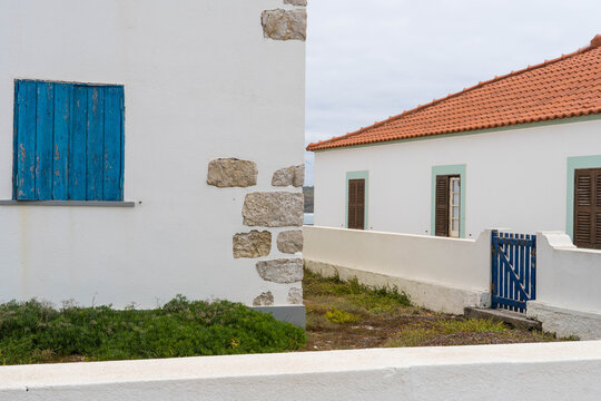 Blue shutters on a old white house.  Baleal, Peniche, Portugal