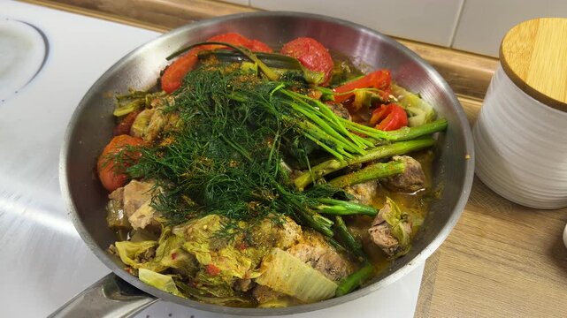 A dish of stewed vegetables in a frying pan. Selective focus.