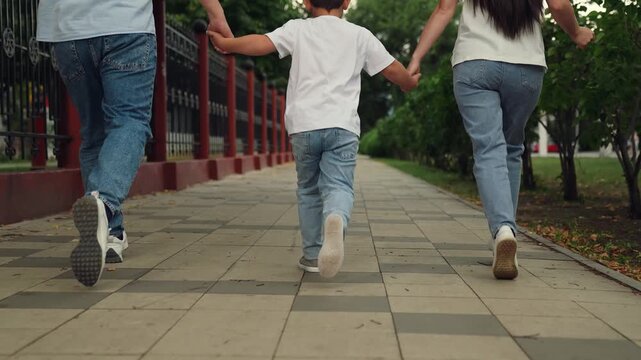happy family, teamwork, group people running feet sidewalk park, little boy parent run happily path outdoors, man woman boy son play superhero, childhood dream run fast, unity people, family uniting