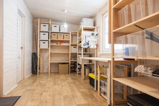 Tool storage room, workshop in a wooden house. Storage racks and boxes