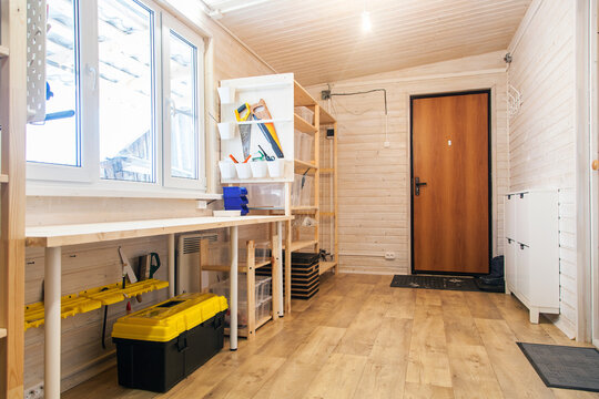  Tool storage room, workshop in a wooden house. Storage racks and boxes