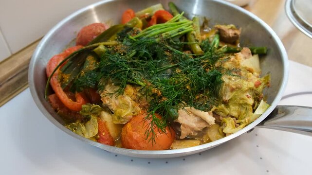 A dish of stewed vegetables in a frying pan. Selective focus.