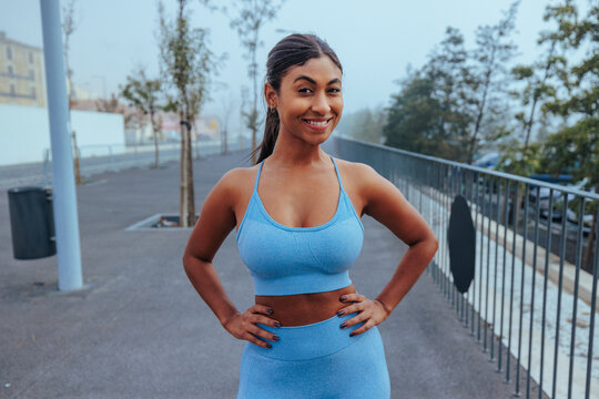 Young woman smiling while exercising outdoors