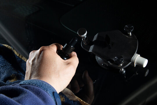 Repair of chips and cracks on car windows. Repair of windshields