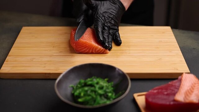 Close-up of a chef slicing fresh salmon on a wooden cutting board. Sharp knife, detailed texture of raw fish, and professional kitchen atmosphere emphasize precision, freshness, and gourmet culinary p