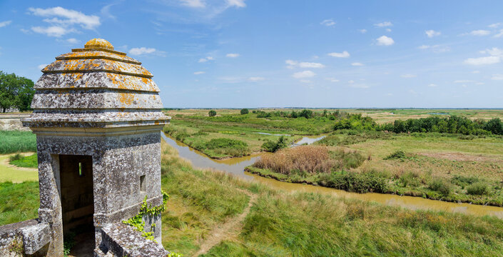 The citadel of Brouage in Charente Maritime, surrounded by high ramparts punctuated with turrets, offers an endless view over flat landscapes of green marshes
