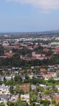 Prestigious Westwood neighborhood in Los Angeles with UCLA campus, Bel Air mansions and wealthy residential properties with swimming pool under blue sky