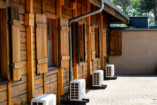Wooden house facade showing air conditioning units
