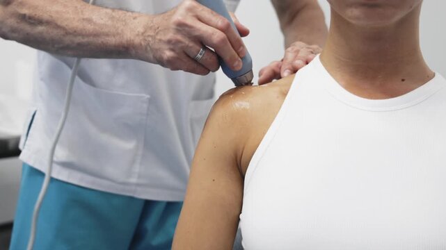 Professional shockwave therapy treatment for woman in medical rehabilitation facility. Concept non-surgical therapy, pain reduction and healthcare.
