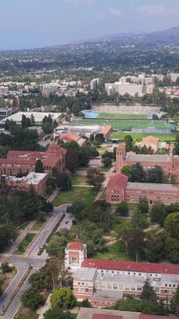 University of California Los Angeles campus showing red roofed buildings, athletic fields, surrounding residential neighborhood
