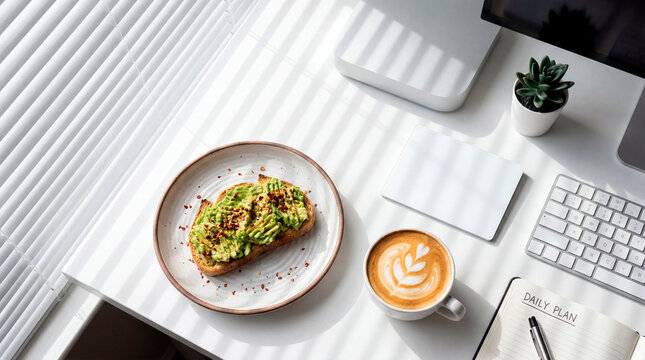 Vegan avocado toast and latte beside keyboard at bright office desk