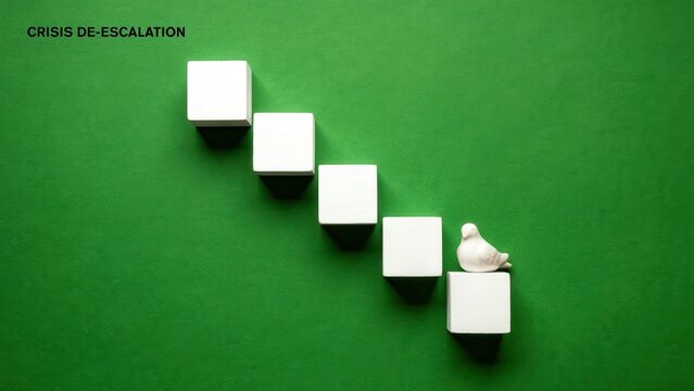 A person sits on a cube in a descending staircase of cubes on green