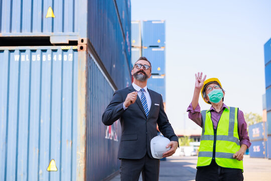 Business man manager or Foreman working with senior man worker at container yard. Unity and teamwork concept. Audience at the morning brief