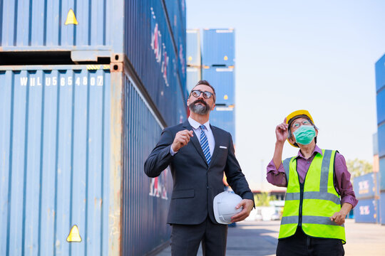 Business man manager or Foreman working with senior man worker at container yard. Unity and teamwork concept. Audience at the morning brief