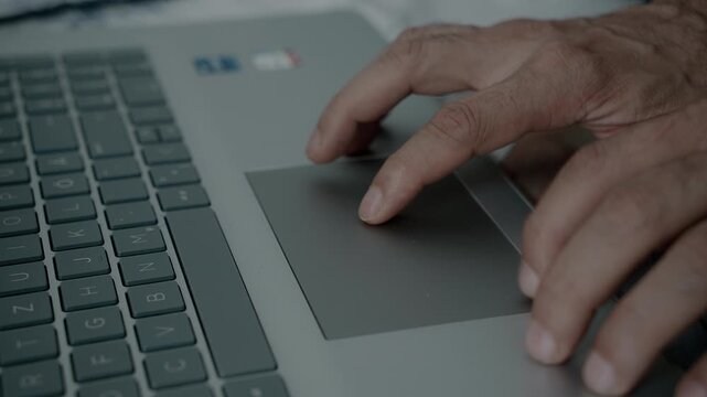 Close Up of Hands Using Laptop Touchpad