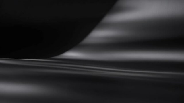 Soft flowing dark waves shown in abstract style on a smooth black background, conveying elegance and calm concept