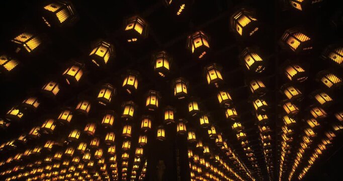 Rows of Glowing Traditional Lanterns at Japanese Shrine At Night - Slow, Low Shot