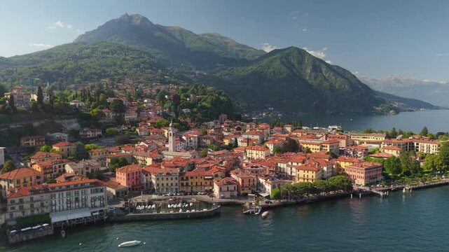 Stunning aerial view of Menaggio at Lake Como resort with beautiful red roof houses. Aerial view of iconic Italian town Menaggio in Lombardy under the green mountain, Como Lake, Italy