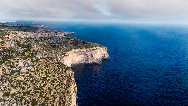 wide angle high drone view of dingli cliffs, malta with Mediterranean Sea below at summer sunset on overcast day