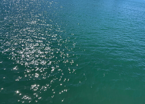Sea blue water glittering surface.