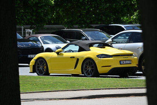 Wroclaw, Poland - June 12th 2026 - Picture of Yellow Porsche Spyder Parked with Other Porsche Cars in Parking Lot