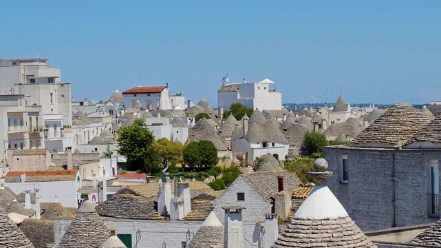 Aerial view of Alberobello traditional white trulli houses, charming Puglia village architecture and UNESCO heritage atmosphere in Italy. 4K video footage