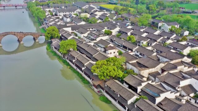 Traditional ancient water town architecture in Hangzhou China with stone bridge over river for historical travel and cultural background