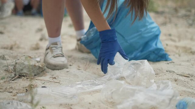 Group volunteers cleaning for ecology. Volunteers working together to protect the environment. Volunteers removing waste to support ecology. Environmental action by volunteer group promoting ecology.