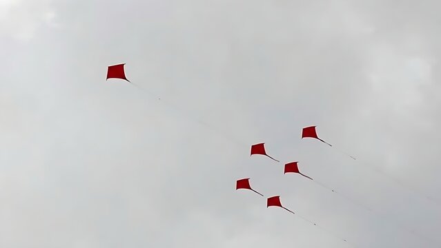 kite. A single red kite drifting away from a formation in the sky. event key visuals, club posters, designed for sports event promotions and stadium branding, used by fitness trainers.