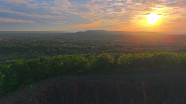 Summer aerial view featuring Chauncey Peak at Doctor Francis Giuffrida Park and the Bradley Hubbard Reservoir in Meriden, Connecticut just before sunset